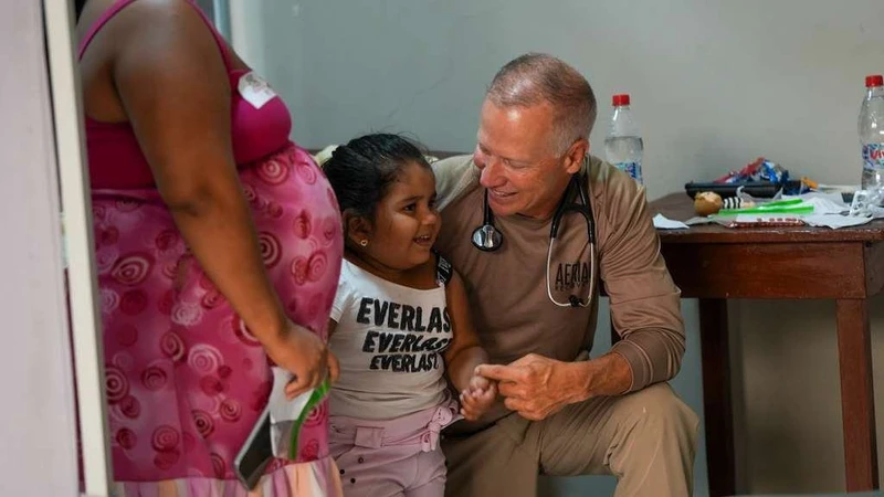 A team physician with a young patient in Canoa