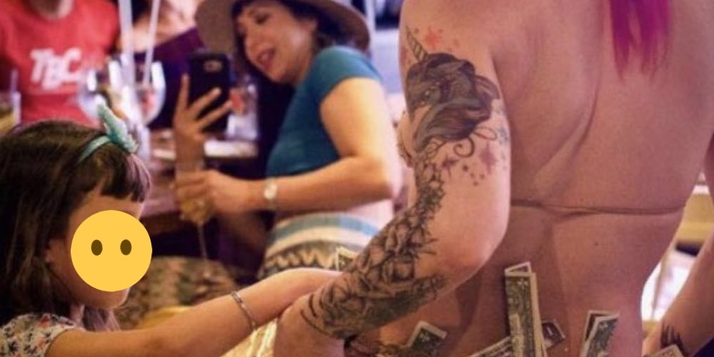 OUTRAGE: Resurfaced photo shows young child putting money in burlesque dancer’s underwear