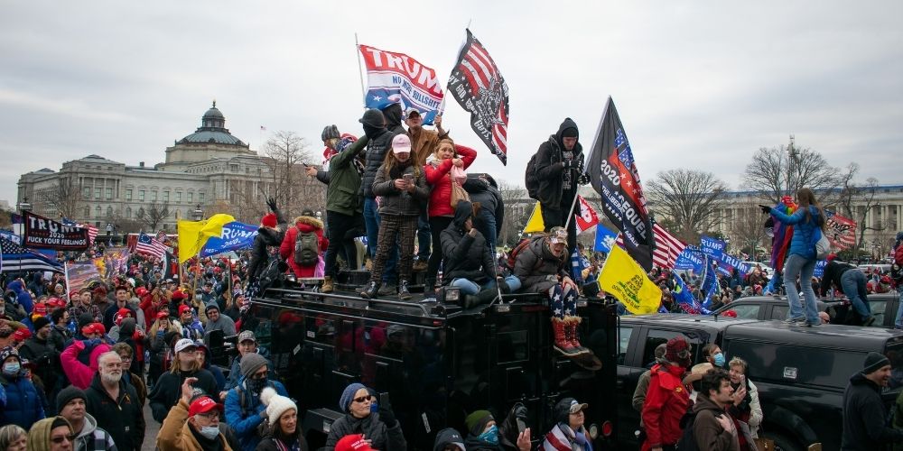 Biden calls Jan 6 an 'insurrection' but no charges filed for that crime