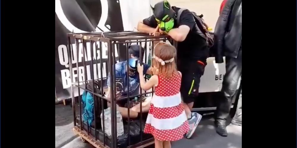 Little girl encouraged to partake in 'puppy play' with caged man at Pride event