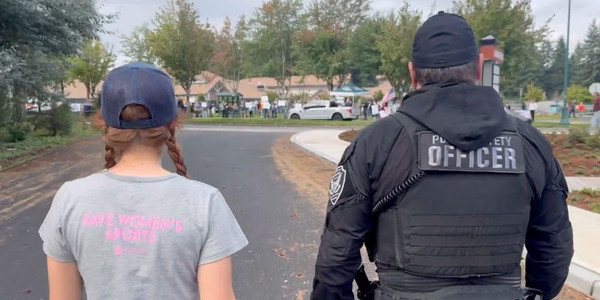 Washington female high school athlete needs police escort to speak out against men in women's sports at protest 
