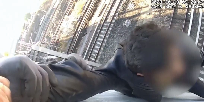 [VIDEO] Cops Rescue Child Dangling From a Bridge As Train Comes Barreling Through
